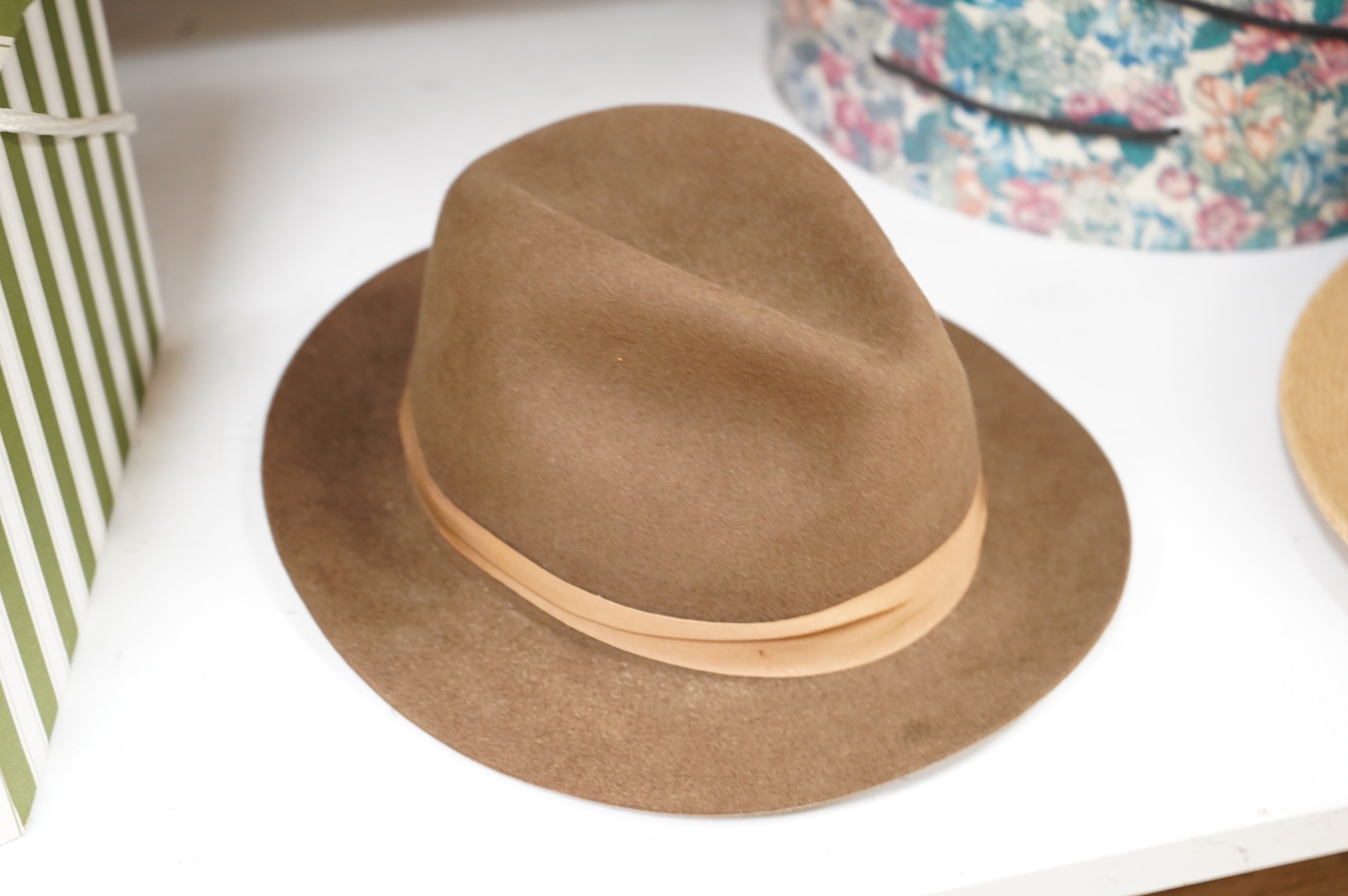 Two hat boxes containing five gentleman's hats; three Fedoras by Locke, Christy’s and Herbert Johnson and two straw Panamas, one by Bates.